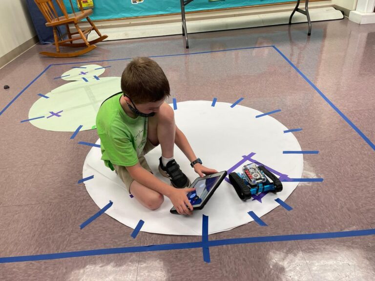 Discovering Robotics: A young learner programs a robot to complete a mission map.